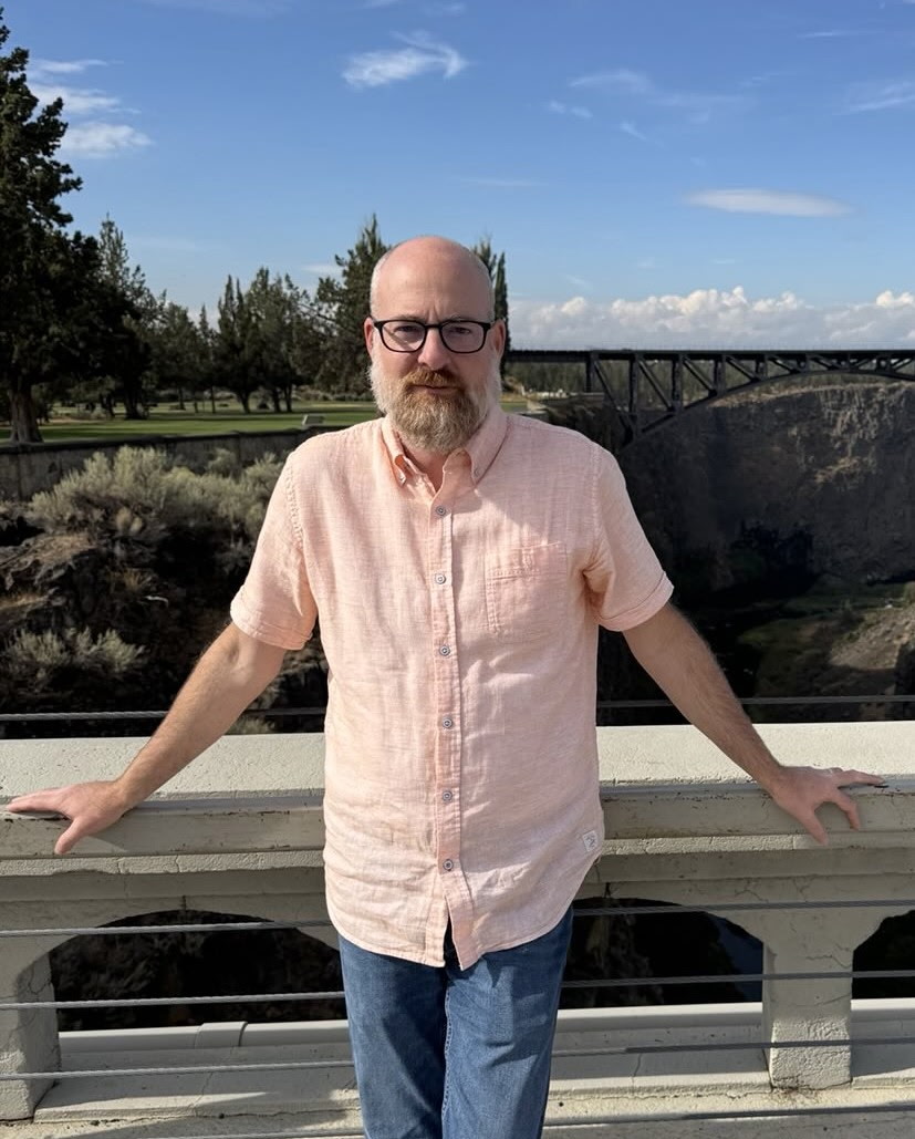 Steve Hewitt standing on a bridge over a Central Oregon river gorge
